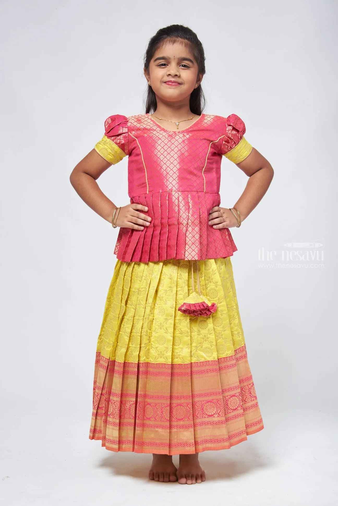 Dazzling Brocade Pink Peplum Top with Banarasi Yellow Pattu Langa: Classic Silk Beauty