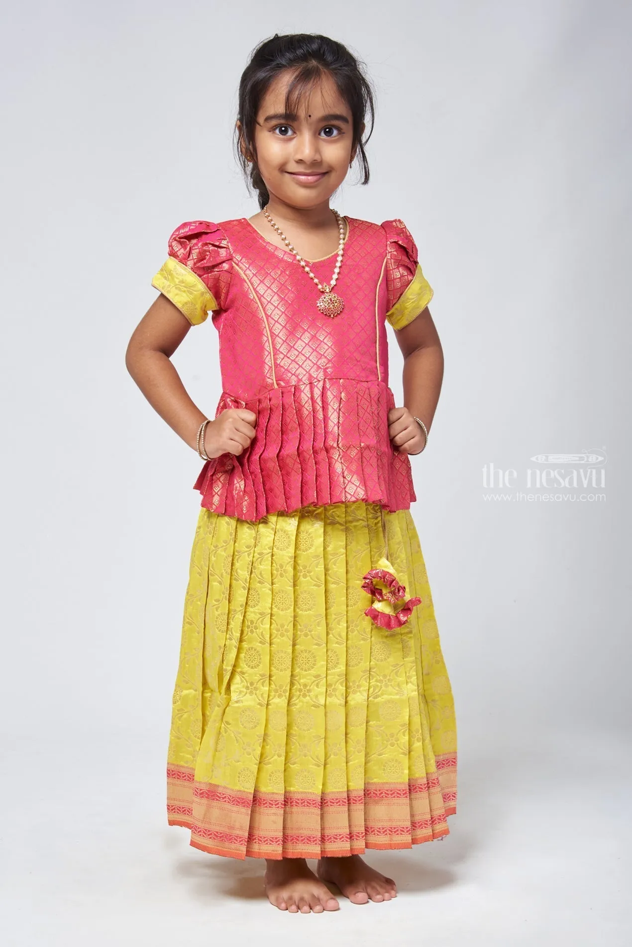 Dazzling Brocade Pink Peplum Top with Banarasi Yellow Pattu Langa: Classic Silk Beauty